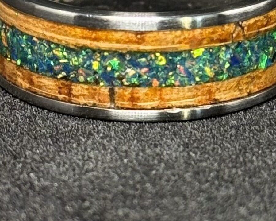 Close detail of the green opal, flashing green, blue and gold under the light.