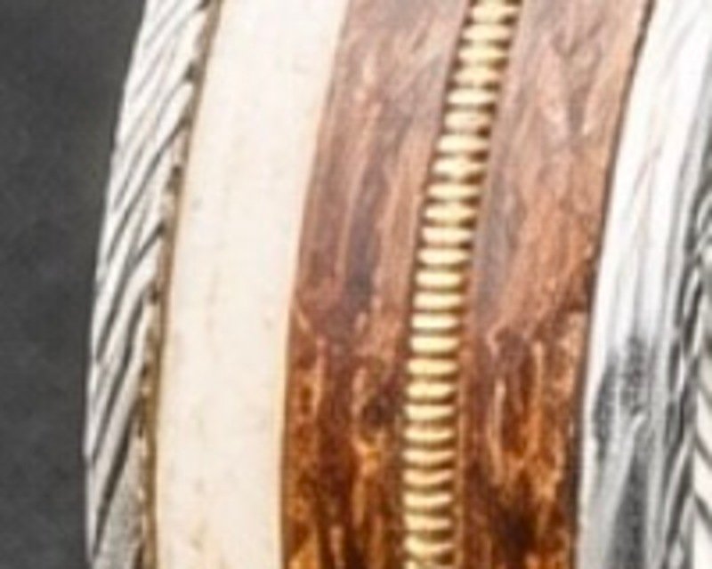 Close detail of the deer antler inlay, pale bone against the steel.