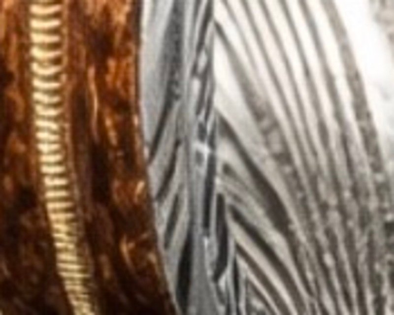 Close detail of the guitar wood inlay, warm brown grain running around the band.