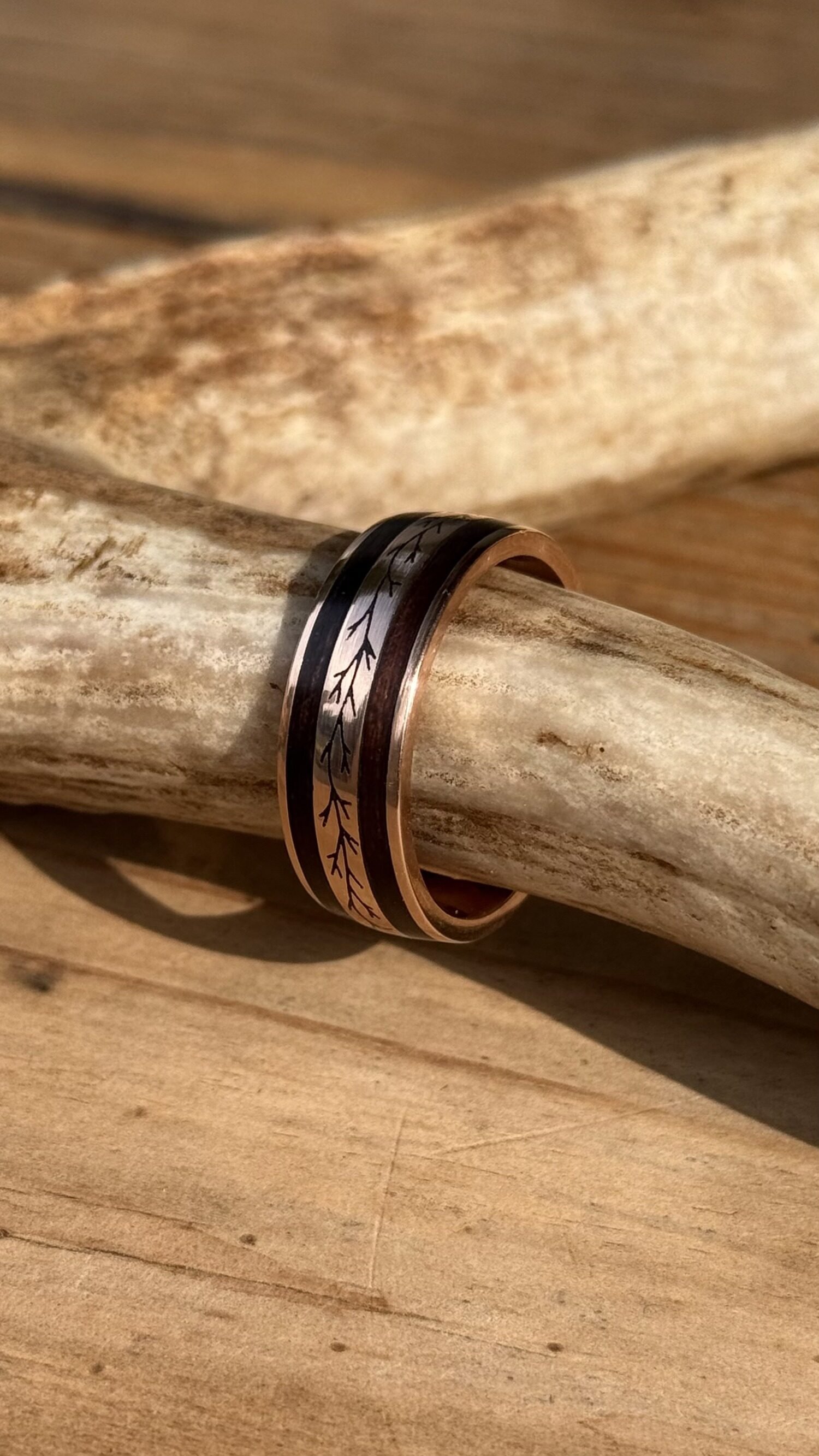 The finished gold band resting against shed antler.