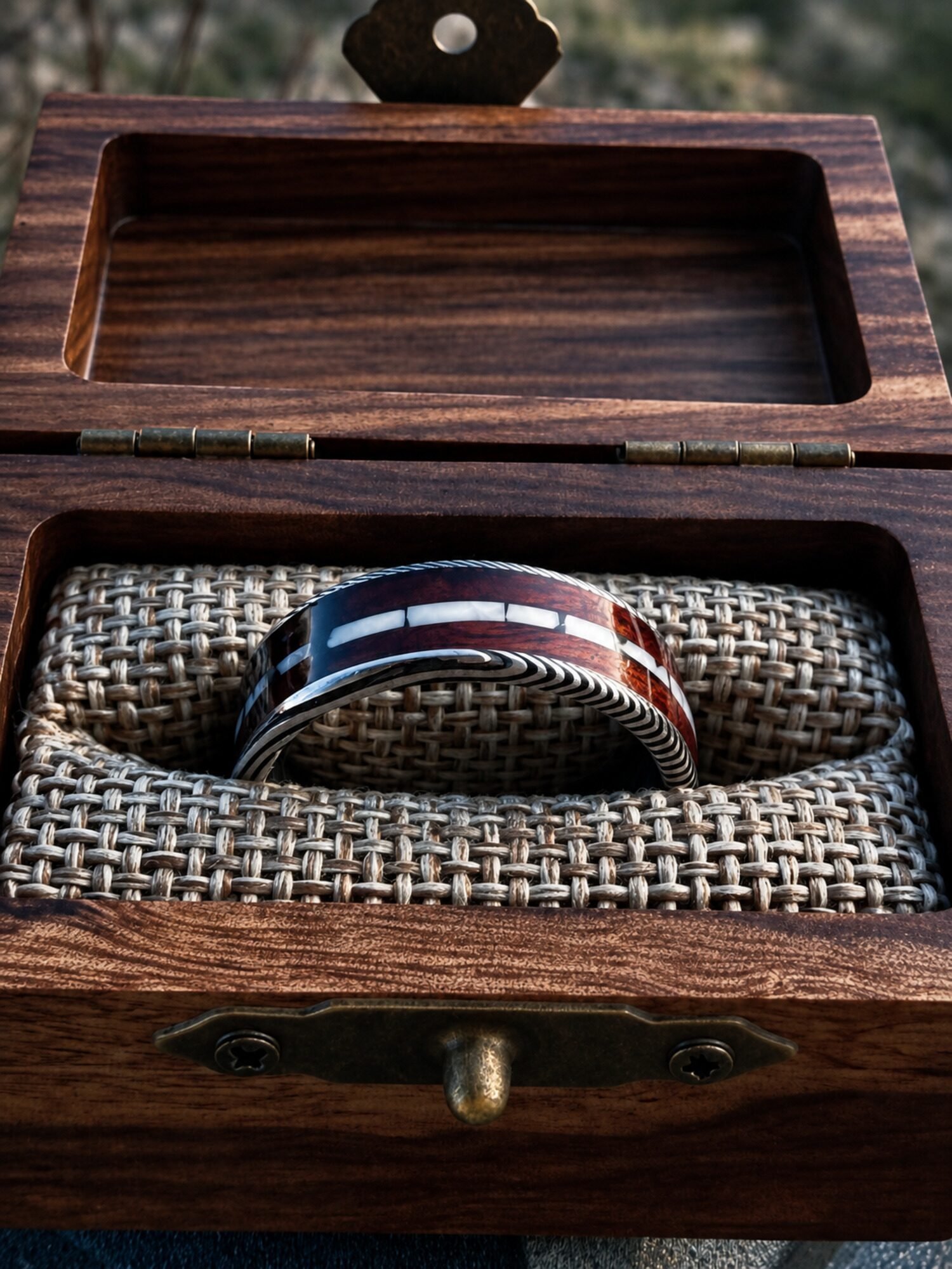 The finished ring in a wooden presentation box.